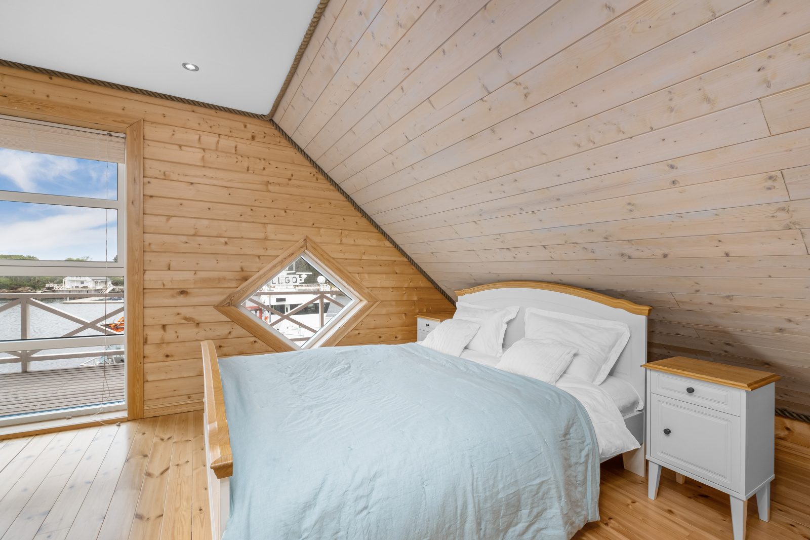 Atlantic Grand — double bedroom with blue duvet and diamond window overlooking the quay