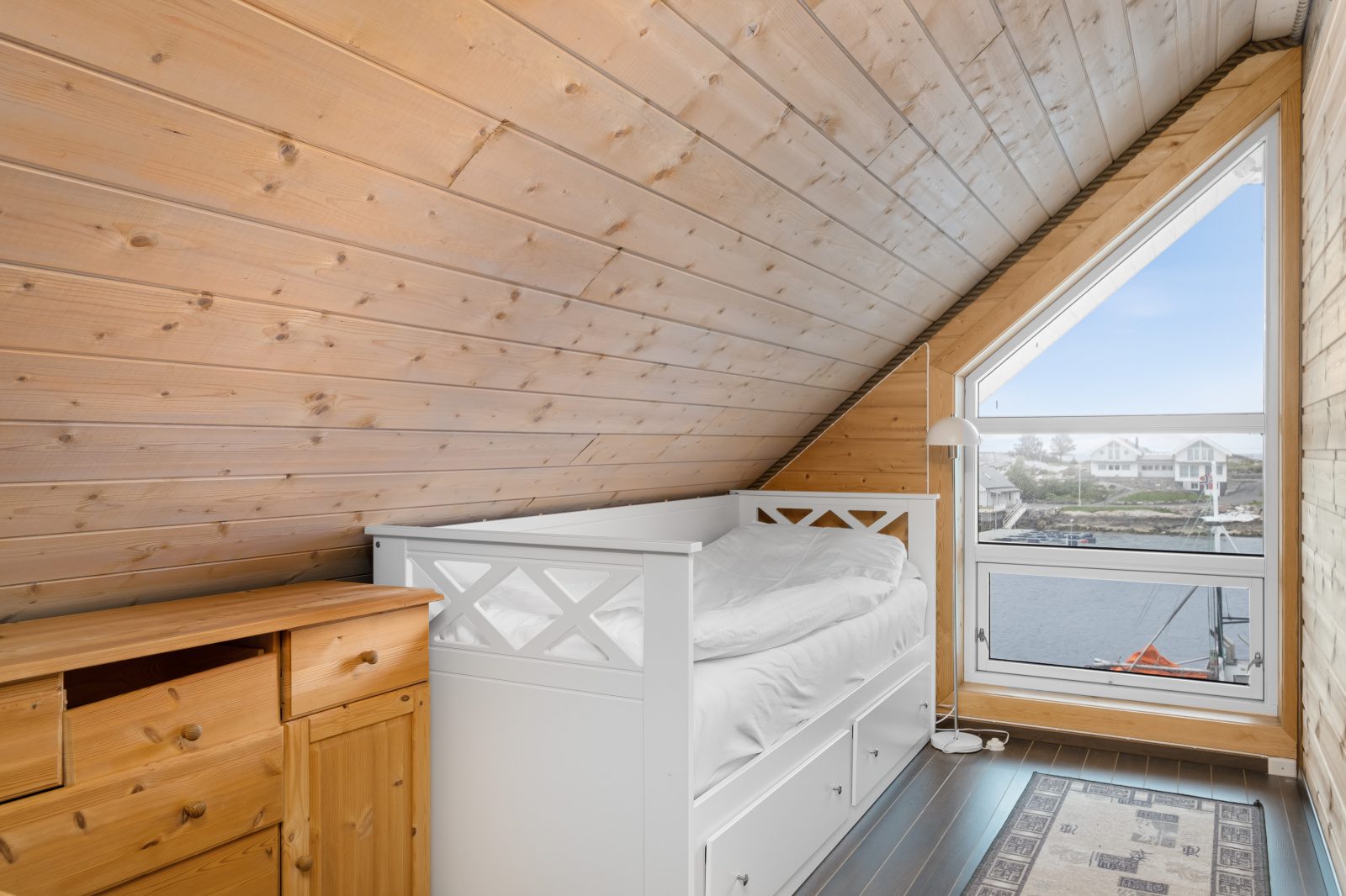 Atlantic Grand — attic single bedroom with white daybed and harbour view