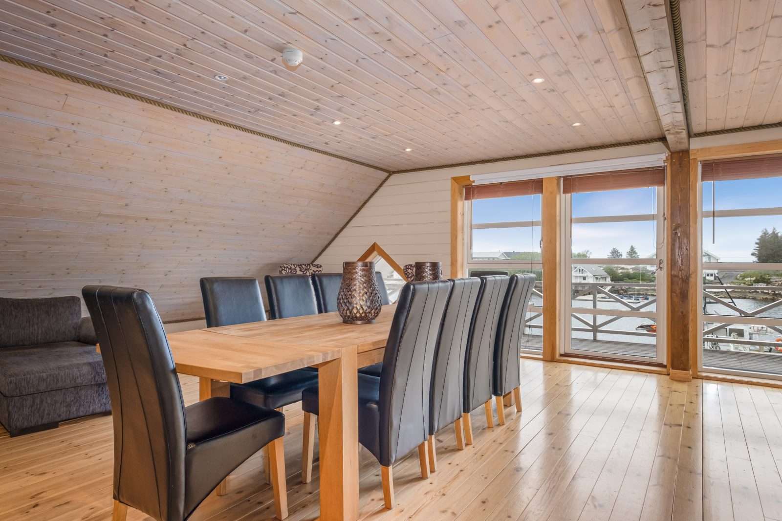 Atlantic Grand — dining table with glass doors opening to the balcony