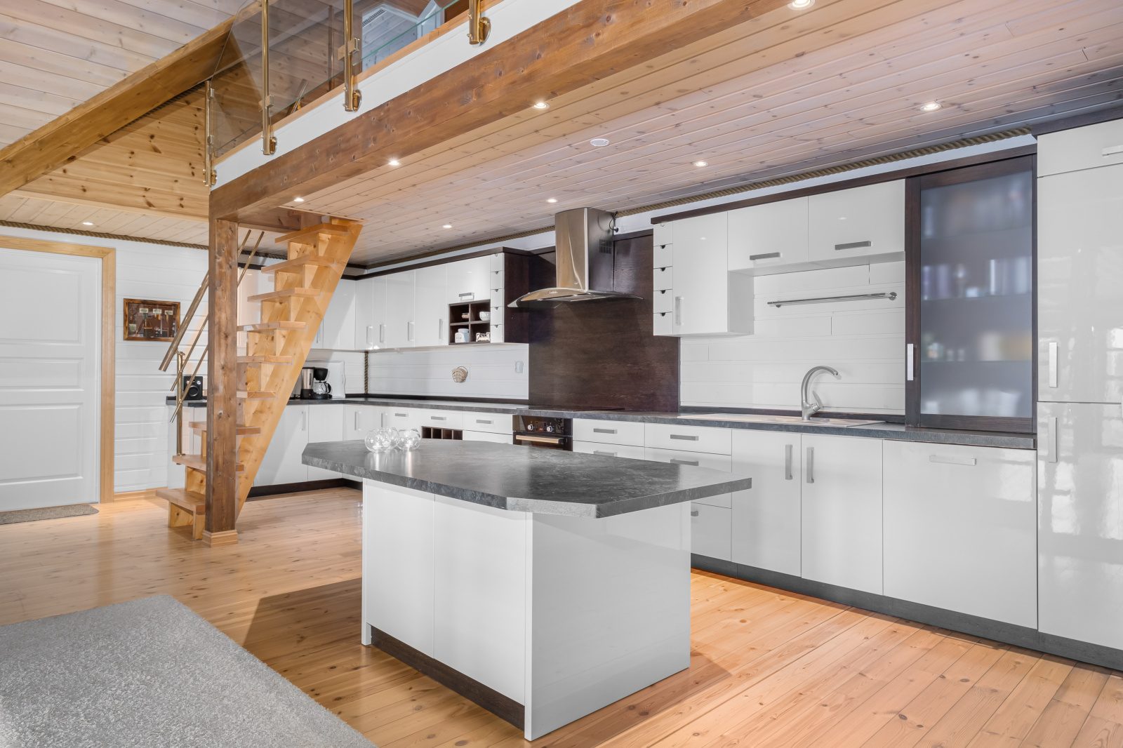 Atlantic Grand — white kitchen with island and mezzanine staircase
