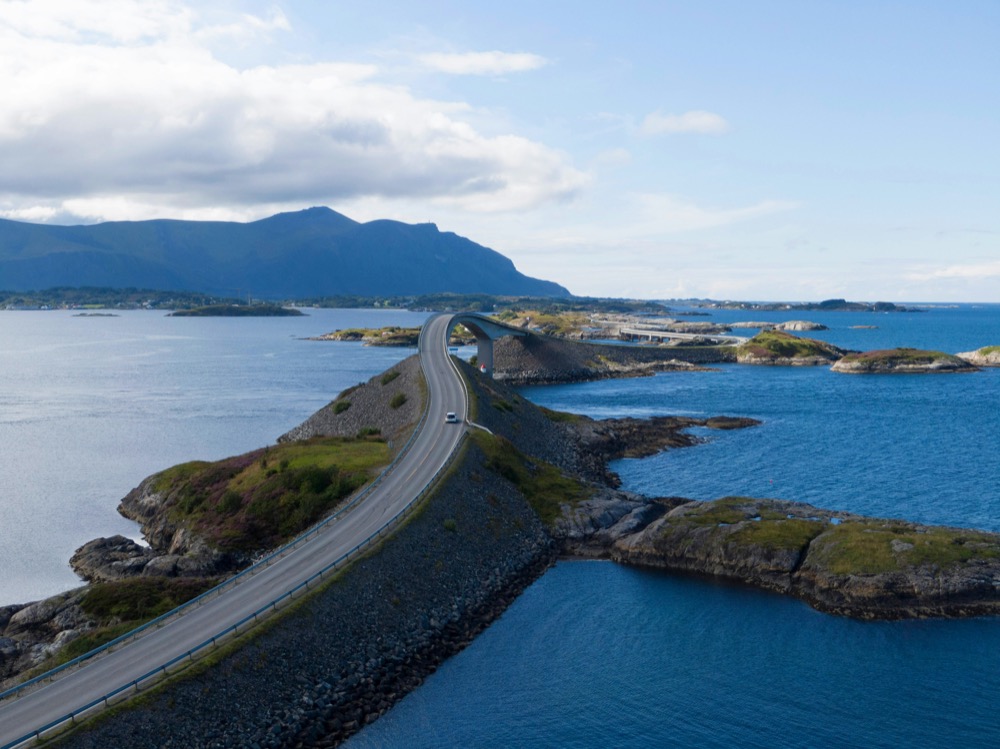 Storseisundet bridge arching over the Atlantic Ocean Road with breaking waves below