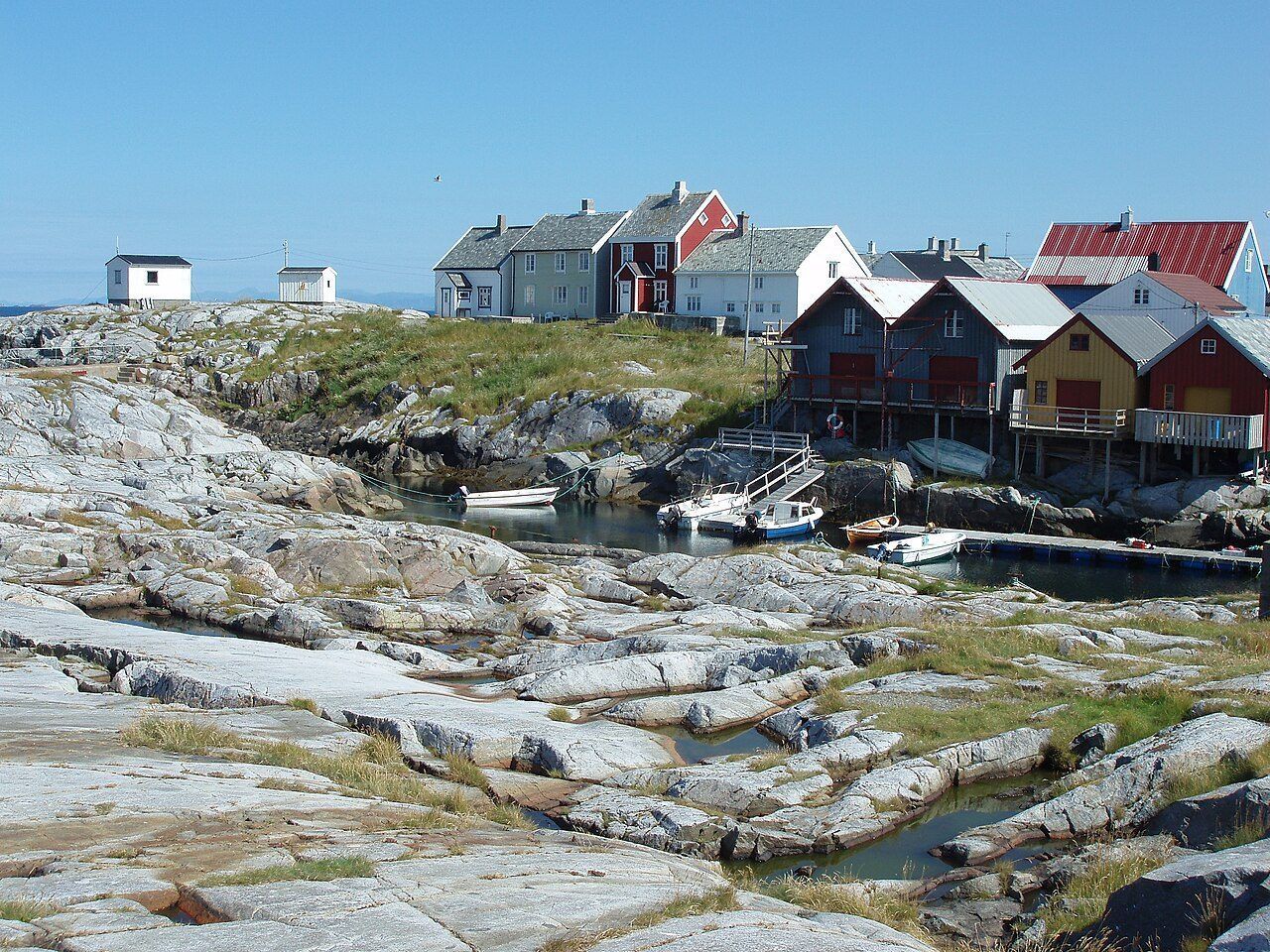 Grip Island's clustered fishermen's houses on the rocky northern shore, seen from the sea