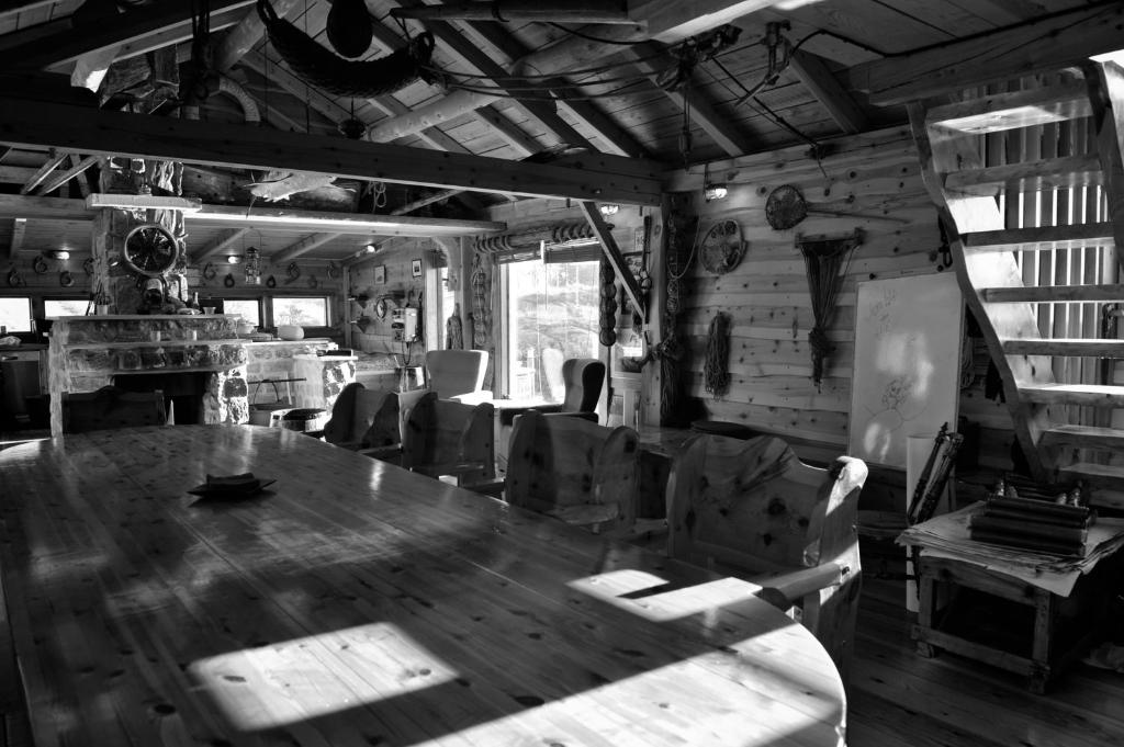 The main room of the on-site museum — a long wooden table, rustic chairs and maritime artifacts on every wall
