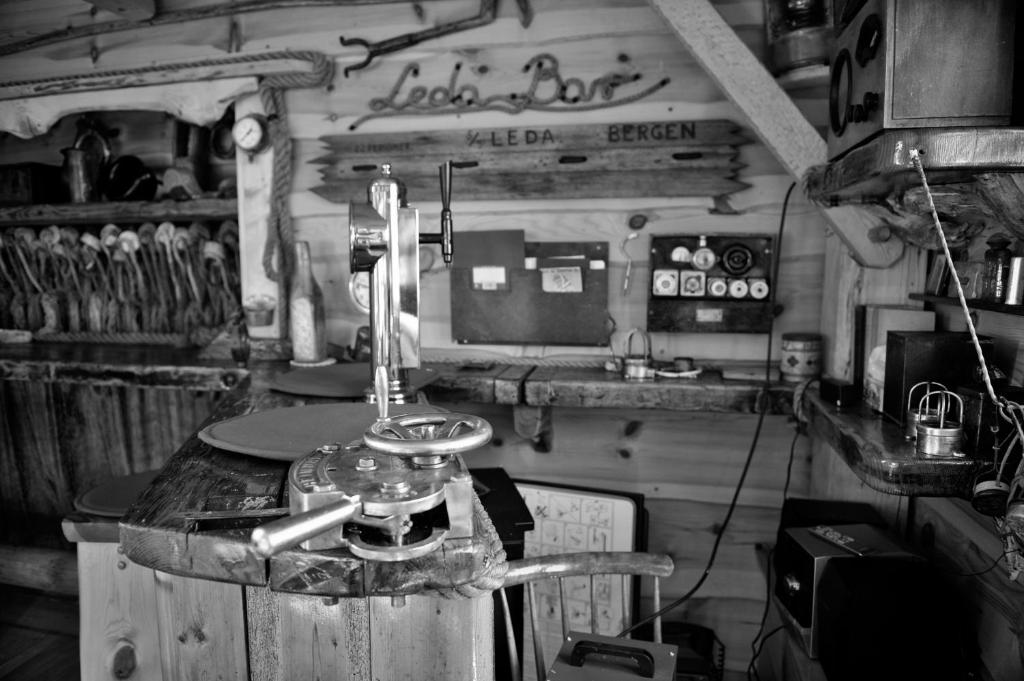 An old rope-making machine with wheel and lever, signed Leda Bergen, inside the museum boathouse