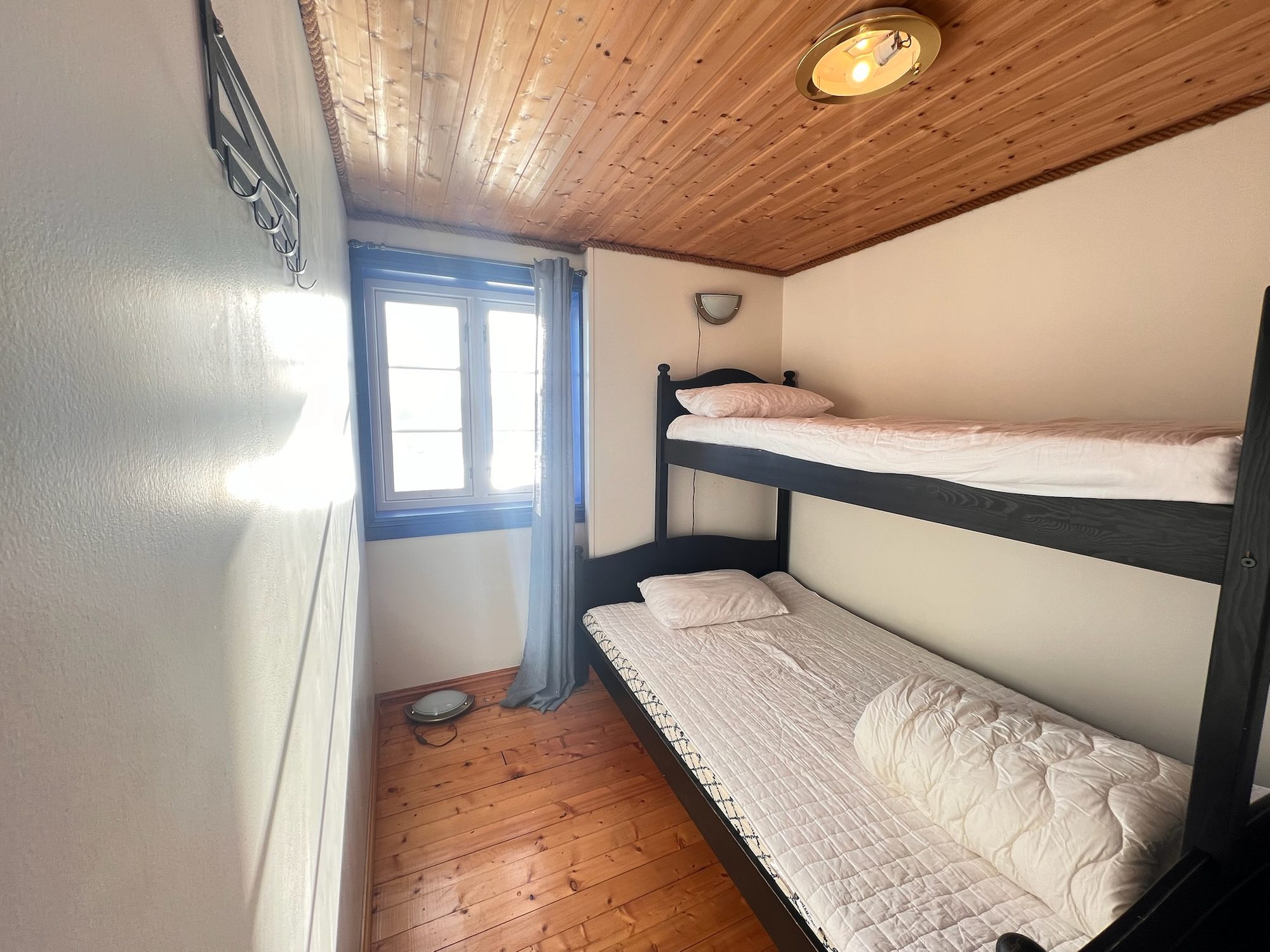 The Heritage — close view of the bunk beds with brass ceiling light
