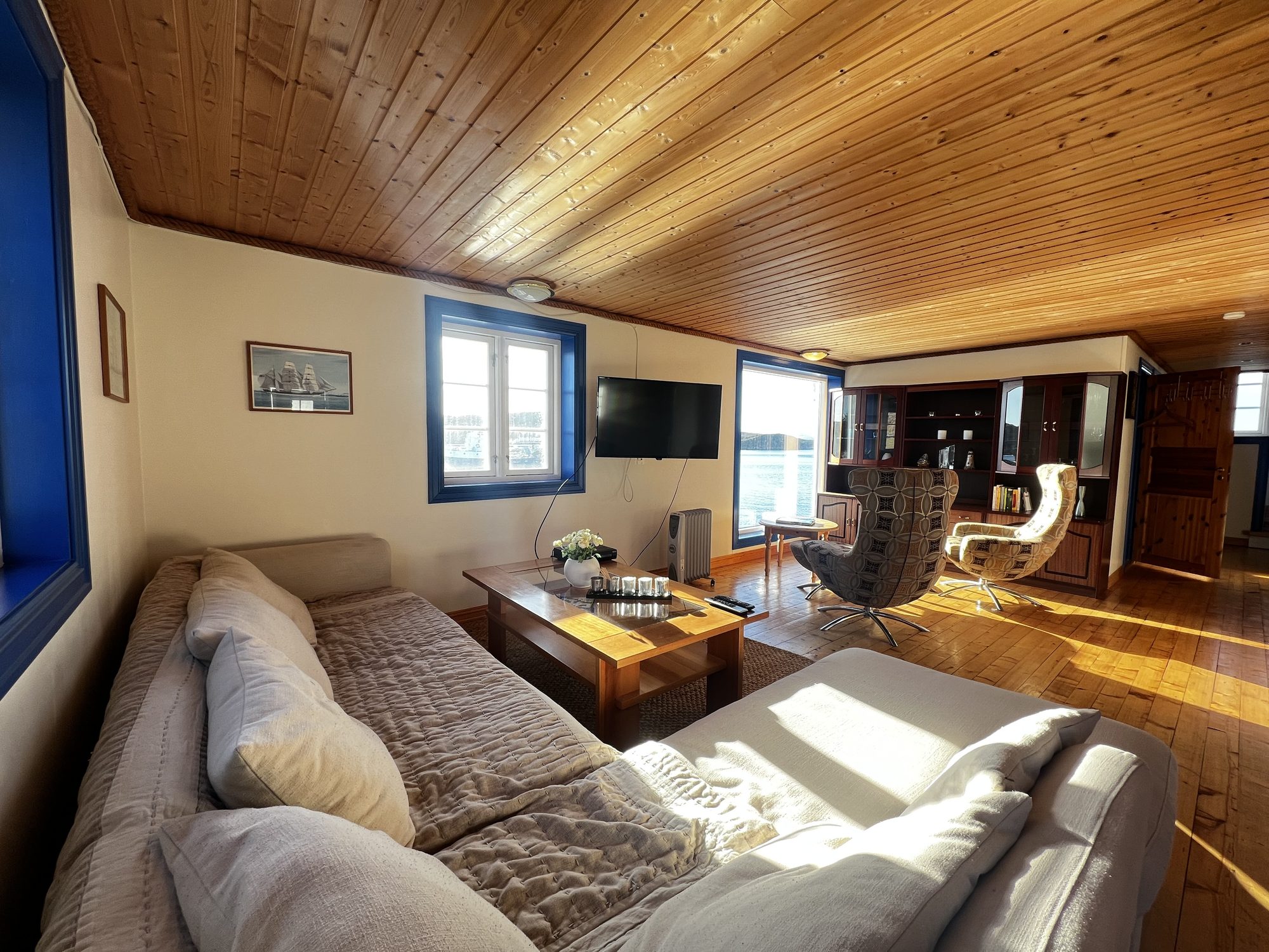 The Heritage — living room with beige corner sofa, coffee table and retro swivel chairs
