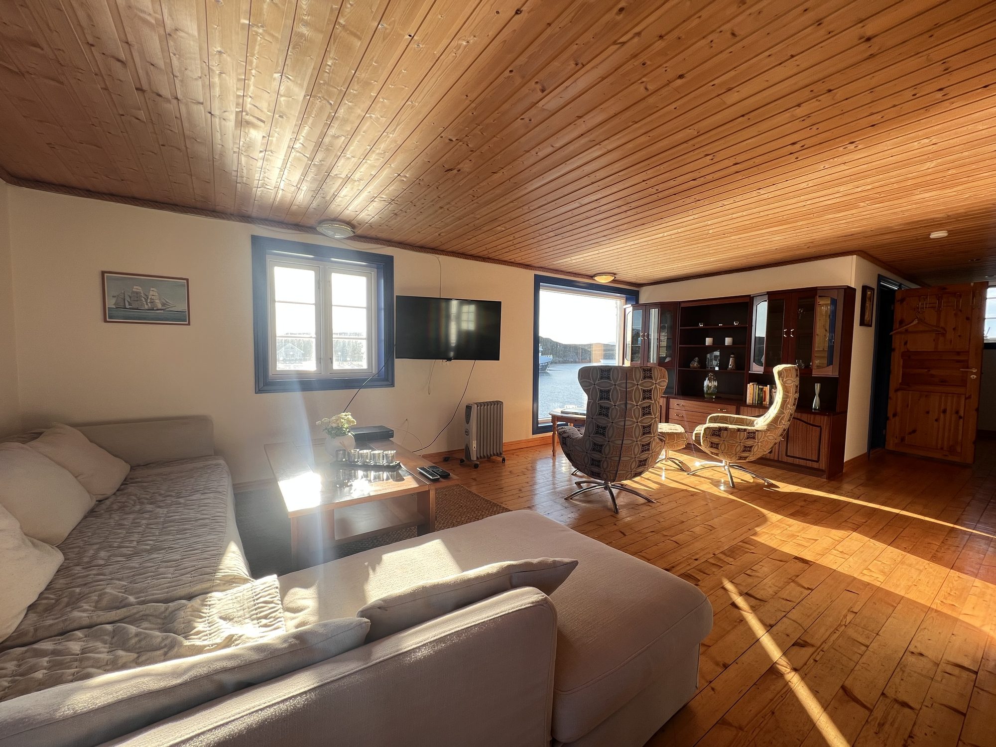 The Heritage — living room with sofa, swivel chairs and display cabinet