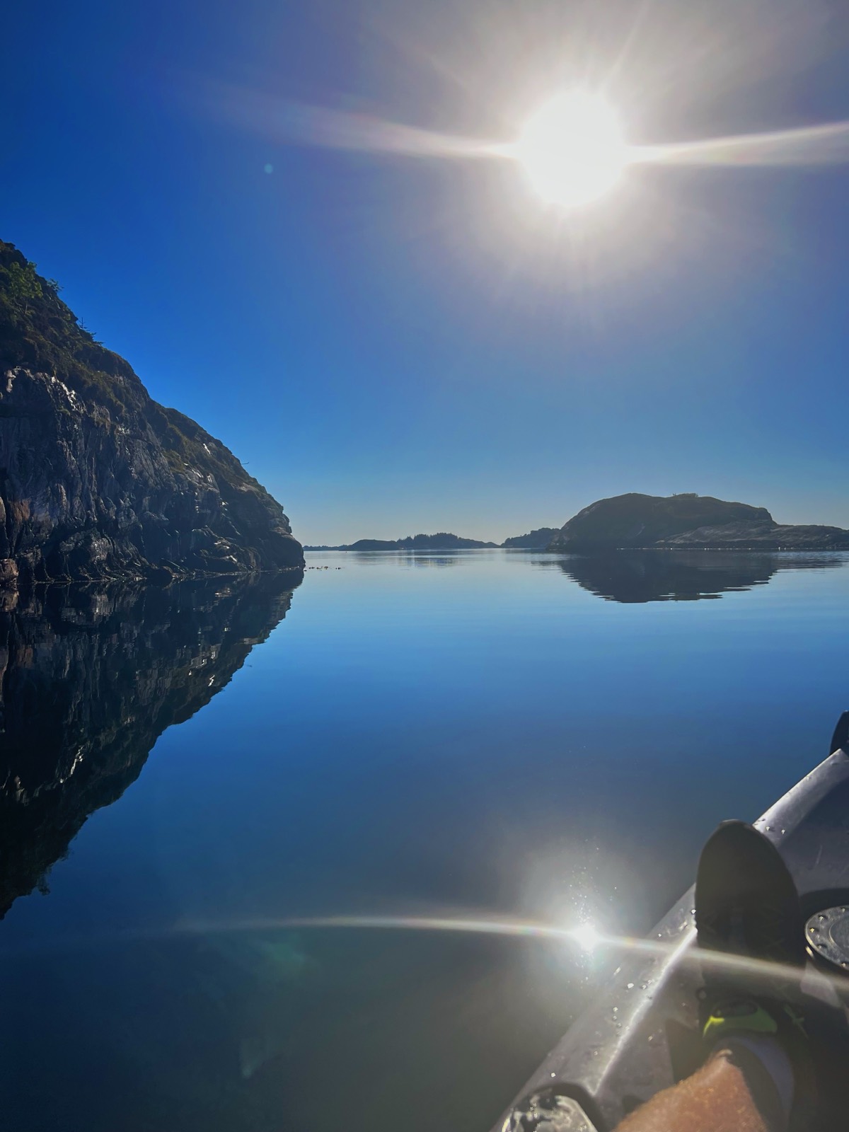 Golden midnight sun reflecting on still water with the sky never fully dark