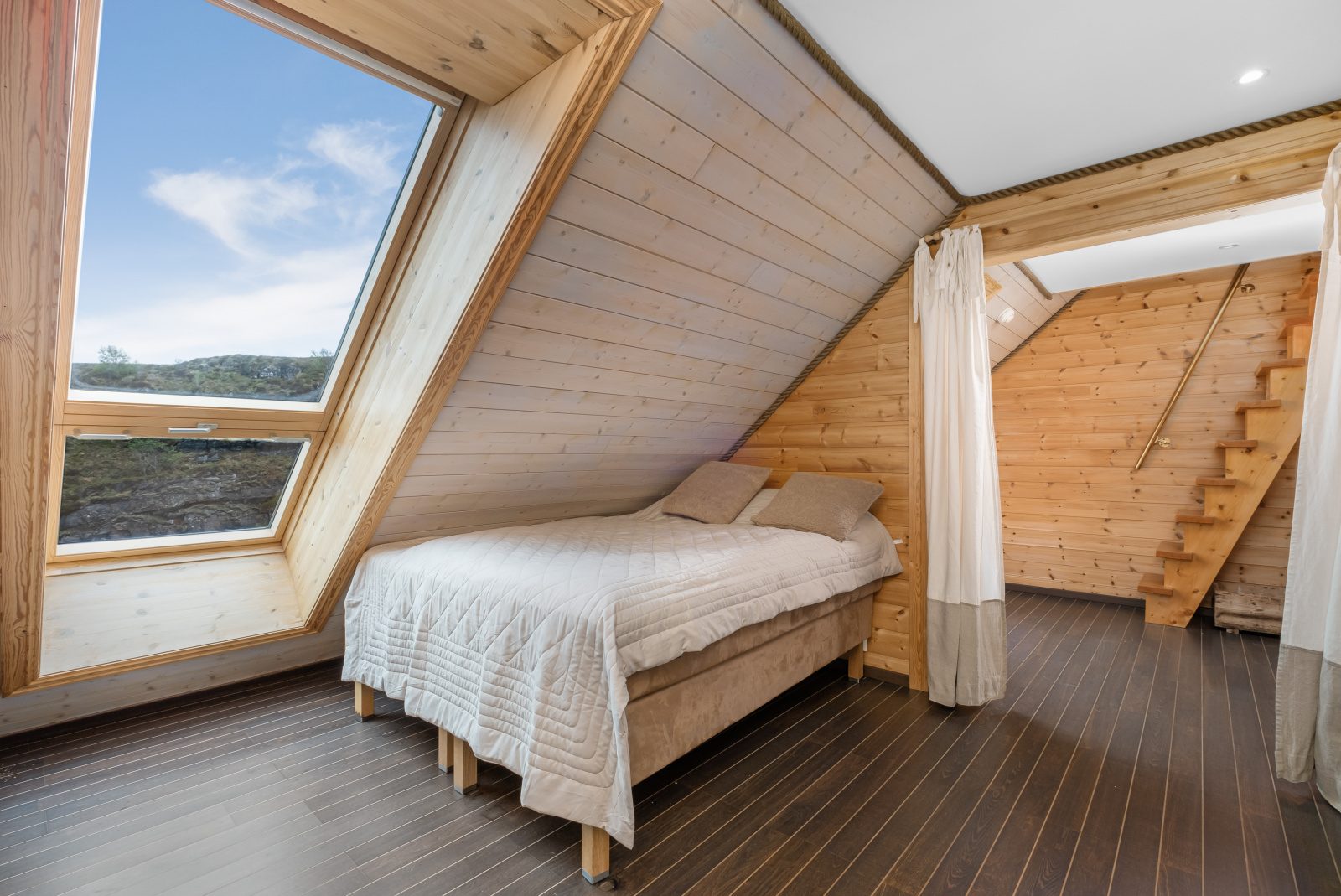 Aurora Suite — loft bedroom with skylight and double bed