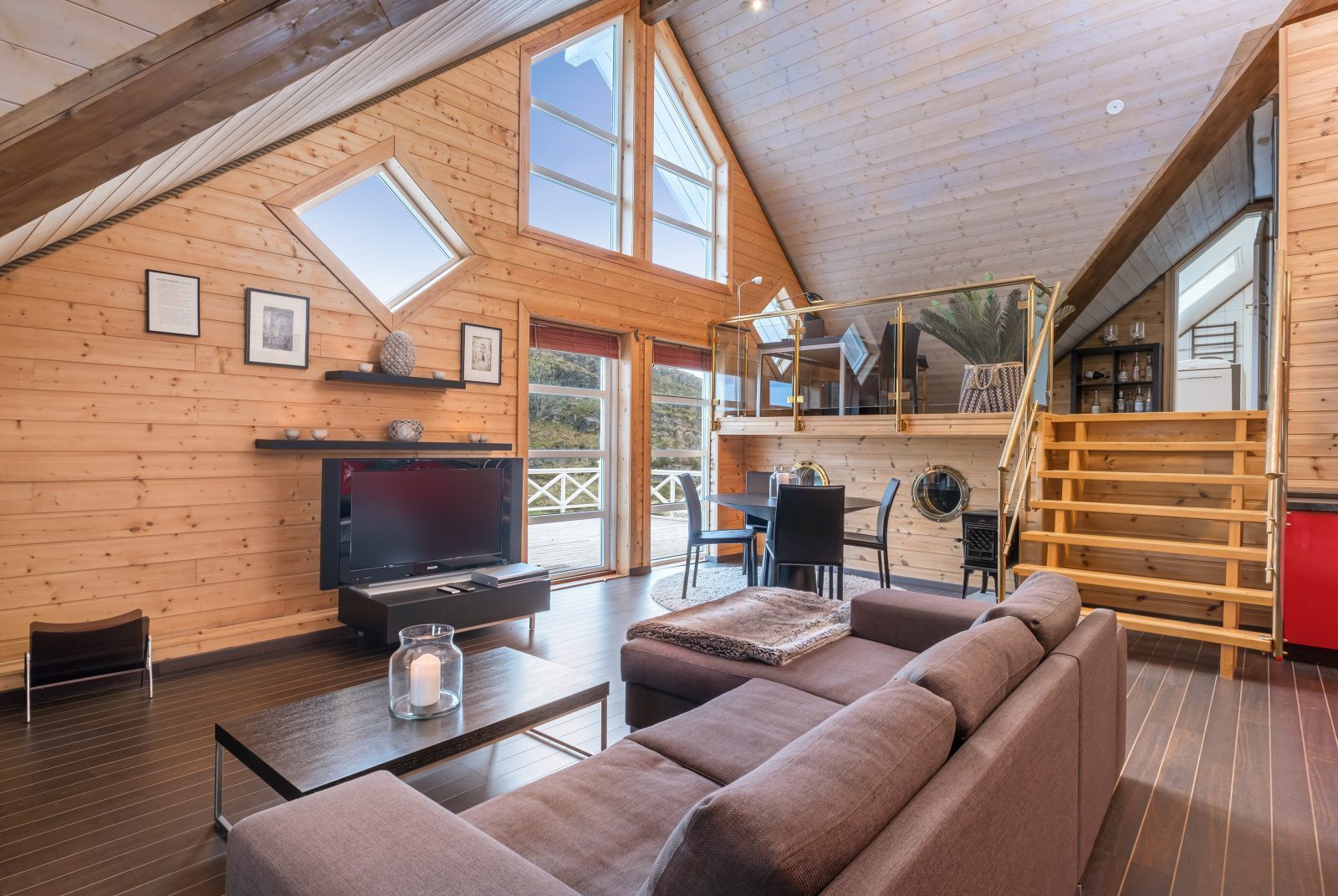 Aurora Suite — open living room with sofa and mezzanine staircase