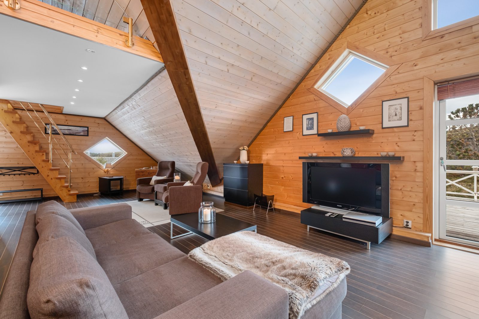 Aurora Suite — living area with flat-screen TV and skylights