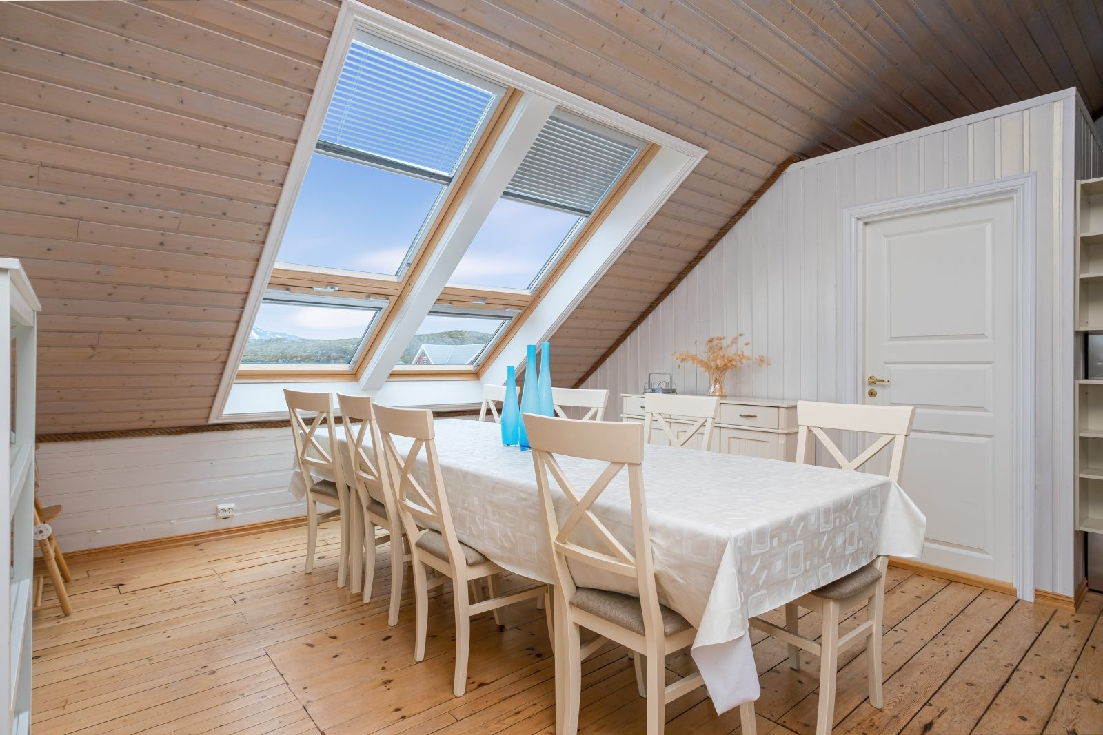 The North Loft — dining table with sea view through skylight