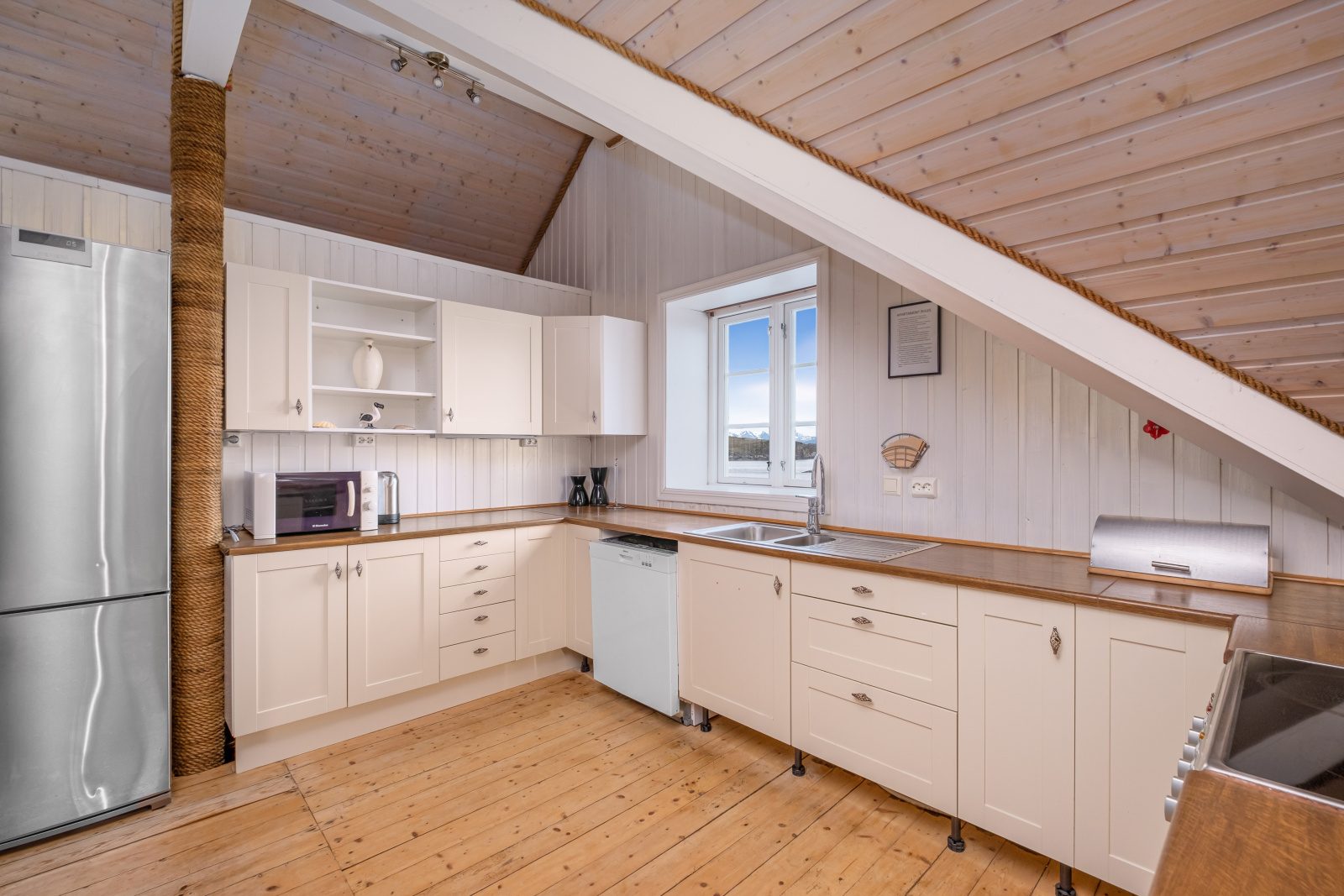 The North Loft — white kitchen with fridge, microwave and dishwasher